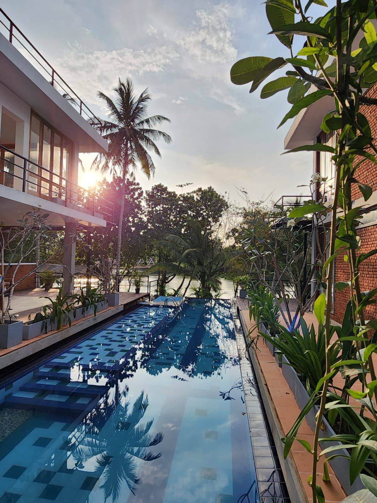 Dusk over the 60-foot infinity pool at Ko Lake Villa looking across Koggala Lake